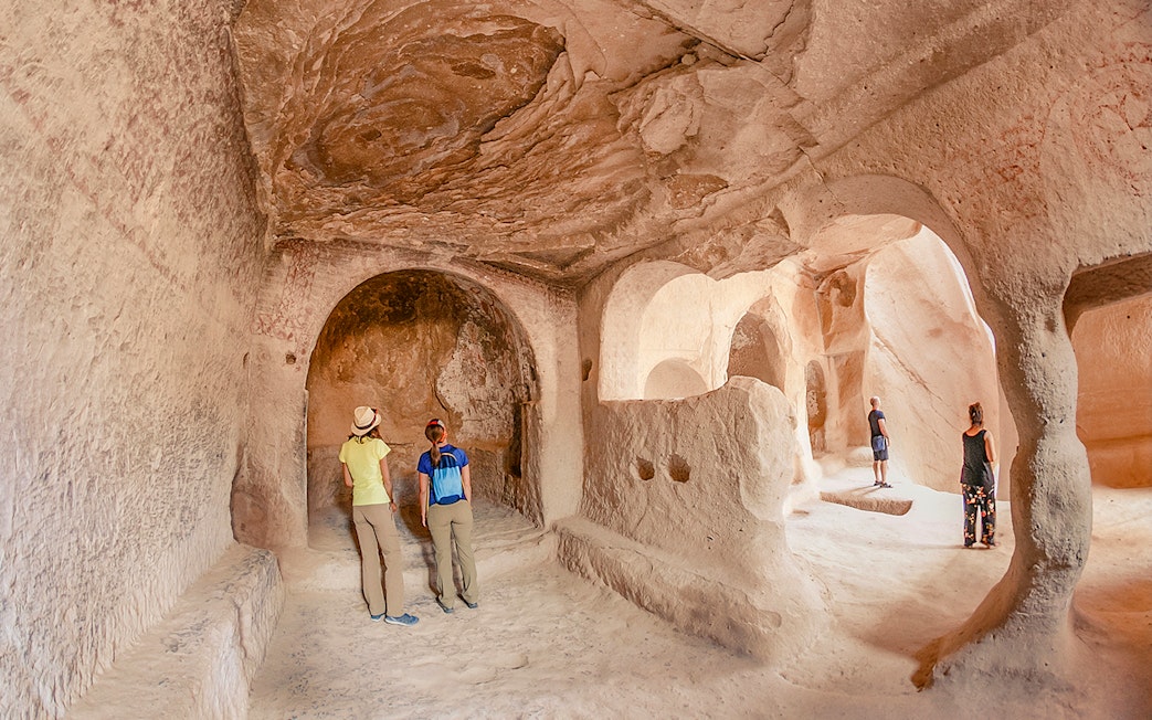 Guests exploring ancient underground city in Cappadocia, Turkey.