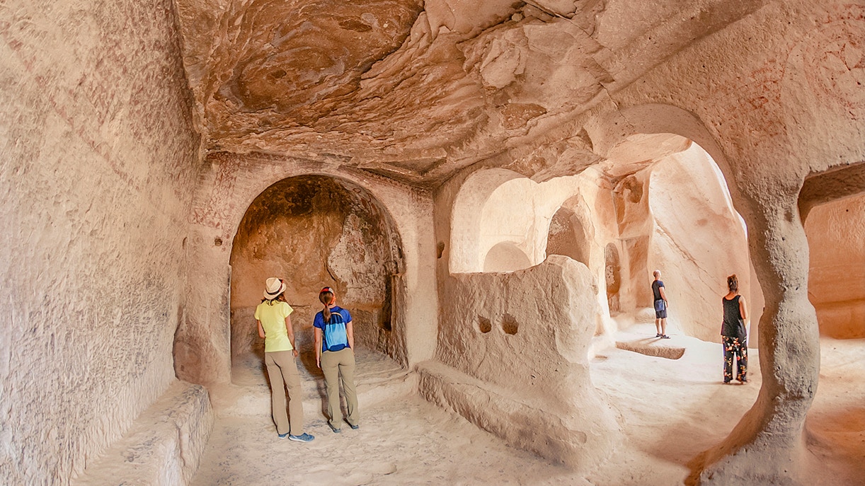 Guests exploring ancient underground city in Cappadocia, Turkey.