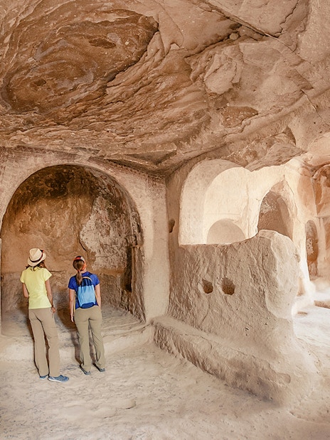 Guests exploring ancient underground city in Cappadocia, Turkey.