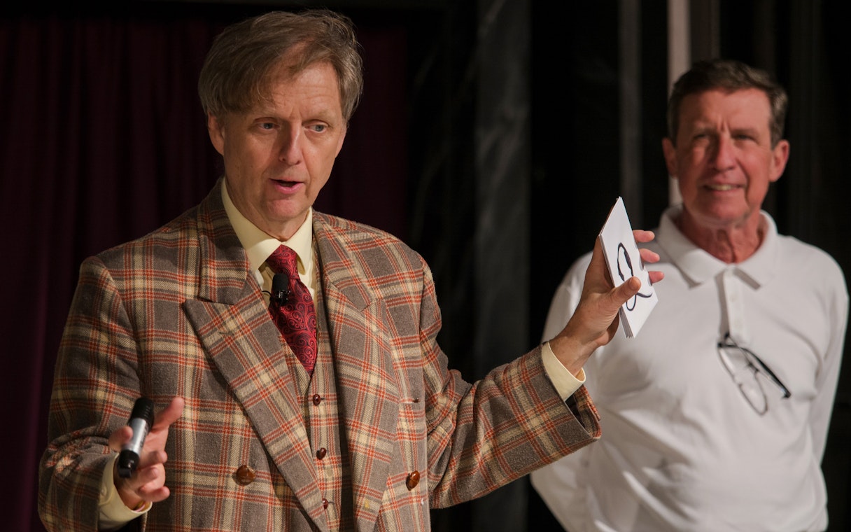 Magician performing card trick at The Mac King Comedy Magic Show, Vegas.