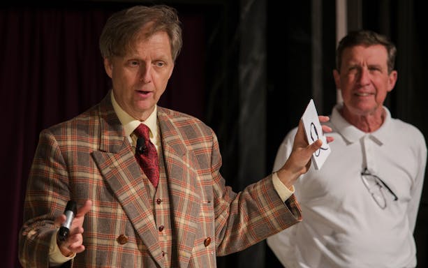 Magician performing card trick at The Mac King Comedy Magic Show, Vegas.