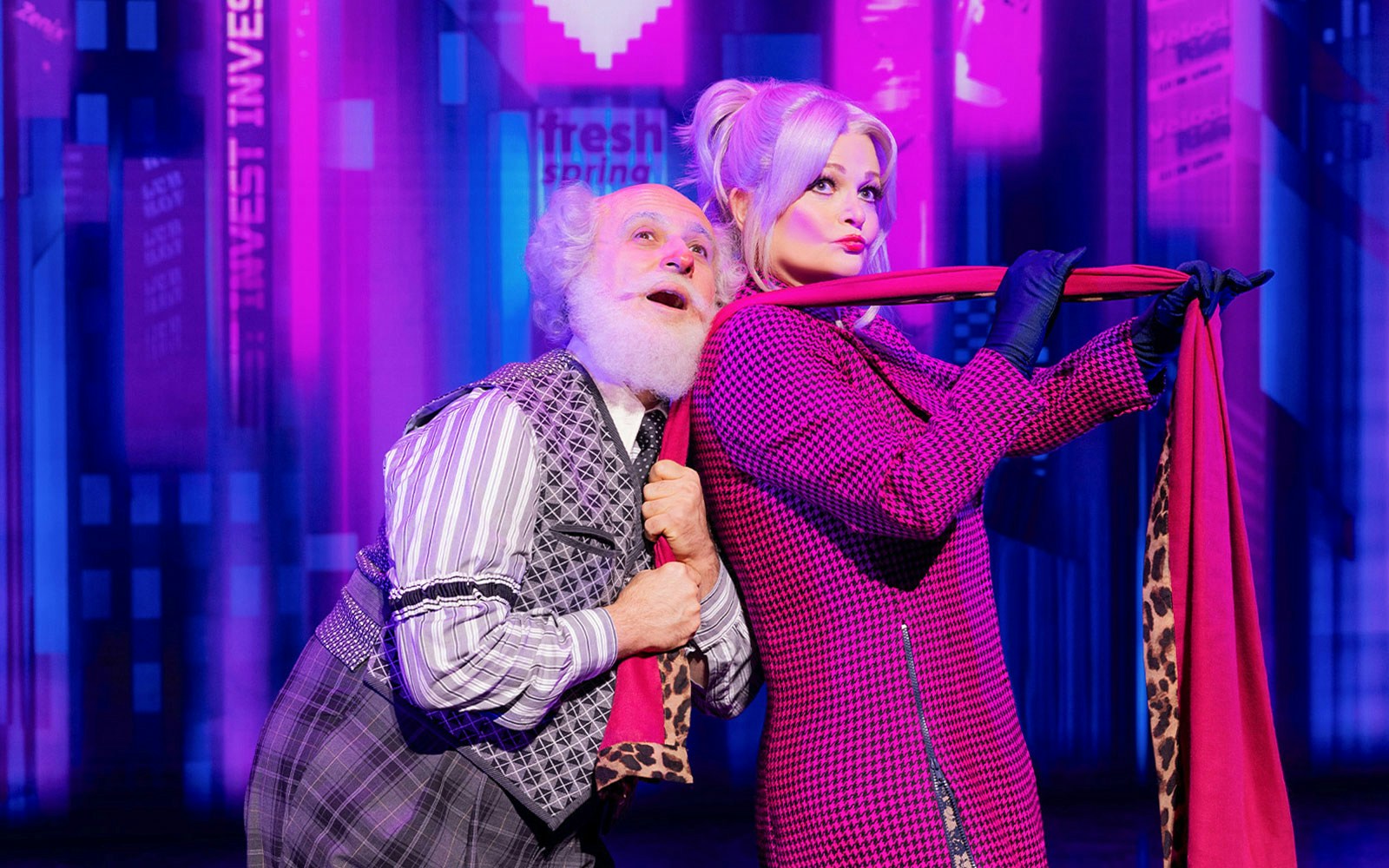 Elderly man and woman in vibrant costumes performing in BOOP! The Betty Boop Musical.