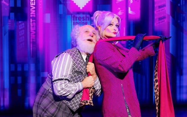Elderly man and woman in vibrant costumes performing in BOOP! The Betty Boop Musical.