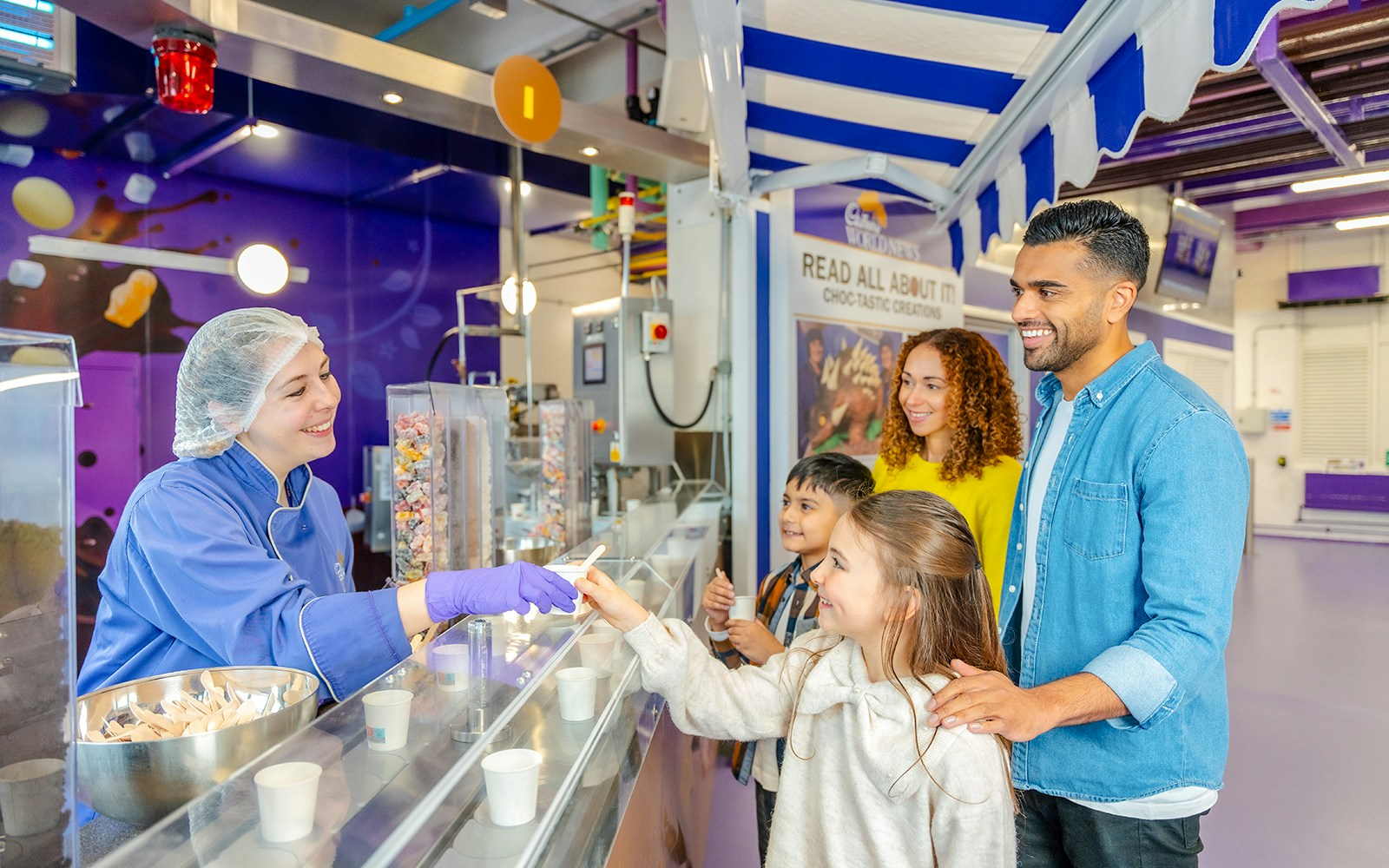 Visitors enjoying chocolate samples at Cadbury World servery.