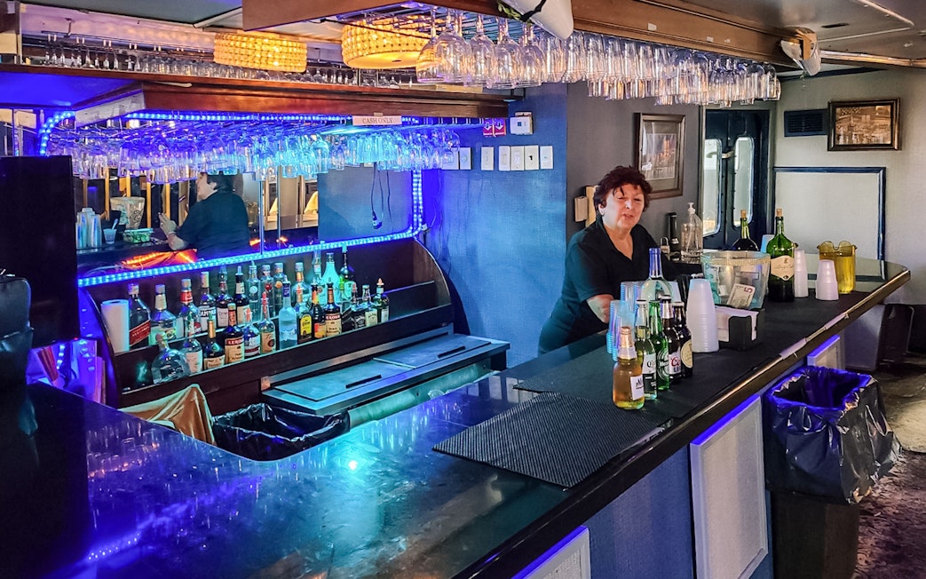 Bar setup on Statue of Liberty Ellis Island Sunset Cruise with bartender and drinks.