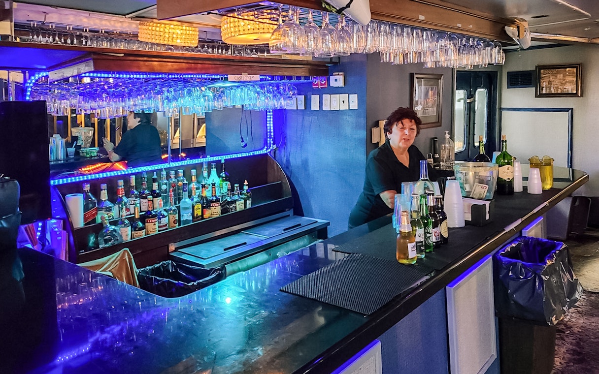Bar setup on Statue of Liberty Ellis Island Sunset Cruise with bartender and drinks.