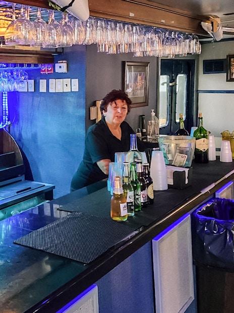 Bar setup on Statue of Liberty Ellis Island Sunset Cruise with bartender and drinks.