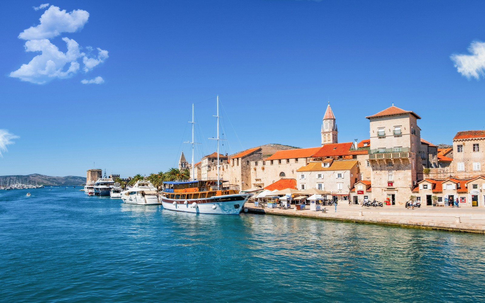 Trogir waterfront with boats docked along Obala bana Berislavića 30, Croatia.