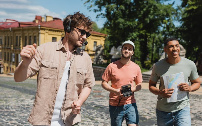 Tourists enjoying a walking tour in Prague with a map and camera.