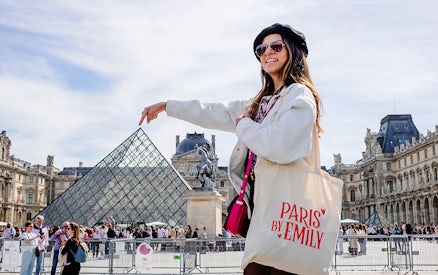 Person pointing at Louvre Pyramid during Emily in Paris Locations Walking Tour.
