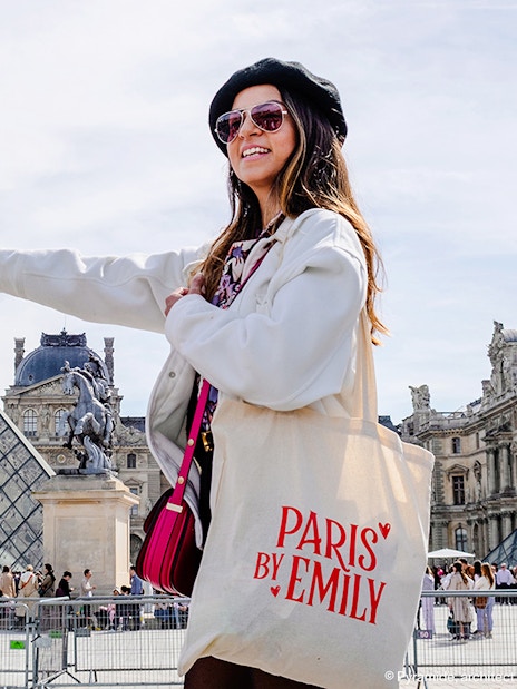 Person pointing at Louvre Pyramid during Emily in Paris Locations Walking Tour.
