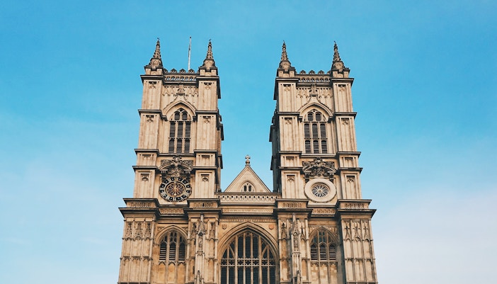Westminster Abbey exterior with tourists in London.