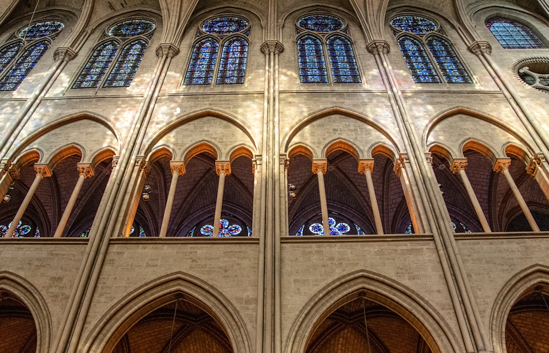 Galleries inside Notre Dame Cathedral showcasing intricate Gothic architecture.