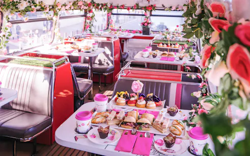 Afternoon tea setup with sandwiches and pastries on Brigit’s Bakery bus tour.