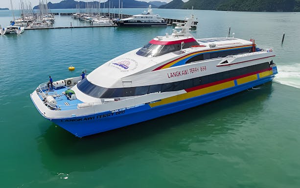 Langkawi ferry docked at port with passengers boarding, Malaysia.