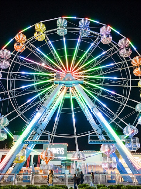 Ferris wheel illuminated at night in Old Town, Orlando.
