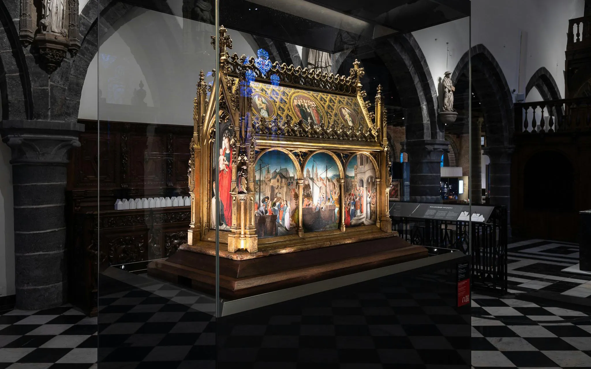 Alt text: "Medieval altarpiece display at Museum Sint-Janshospitaal, Bruges.