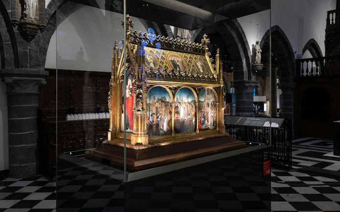 Alt text: "Medieval altarpiece display at Museum Sint-Janshospitaal, Bruges.