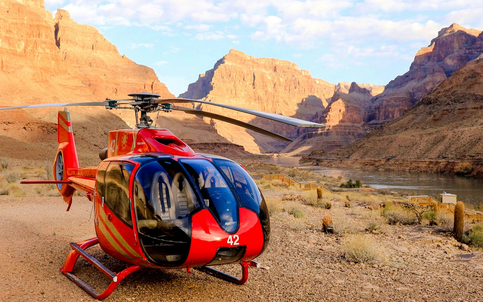 Helicopter flying over Grand Canyon West Rim with river view, part of 15-min tour including floor landing and boat ride.