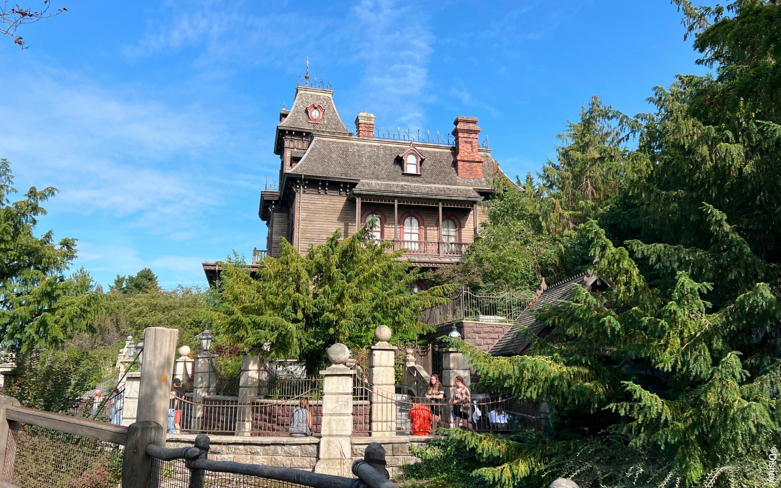 Phantom Manor at Disneyland Paris with eerie Victorian architecture and surrounding gardens.