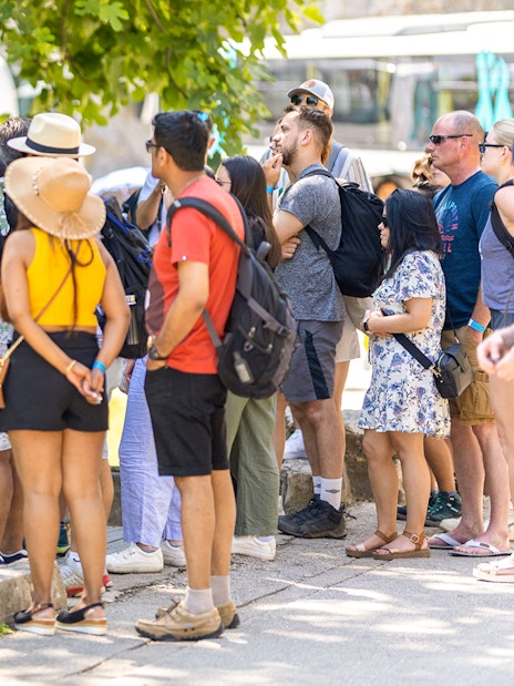 Tour group listening to a guide at Krka Waterfalls, Croatia.