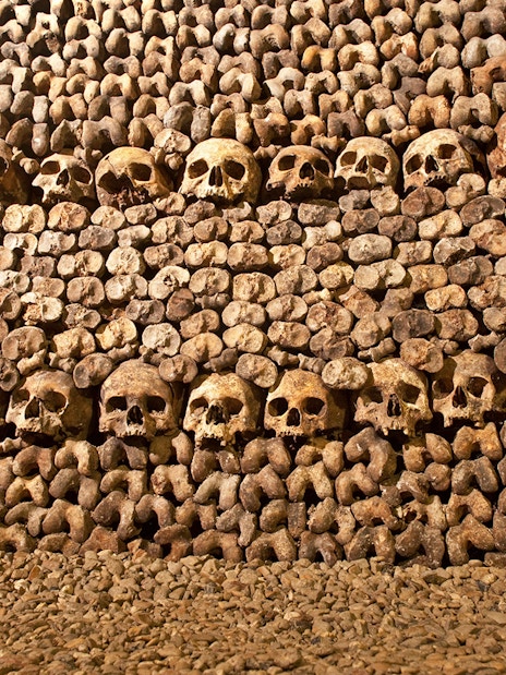 Skulls and bones arranged in the Catacombs of Paris.