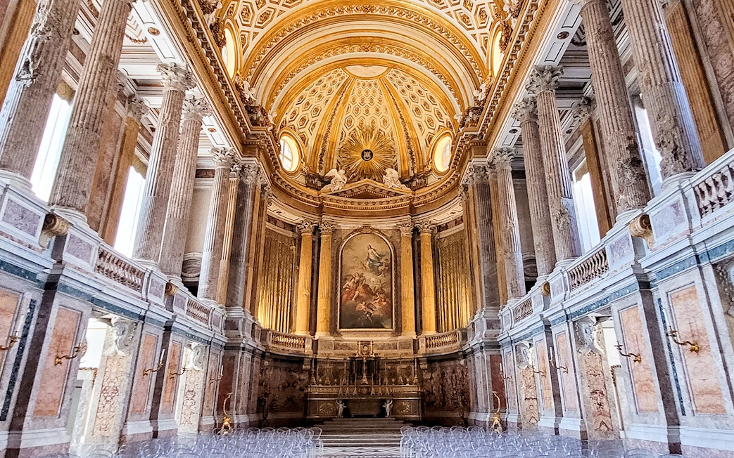 Palatine Chapel interior with ornate ceiling and columns, Royal Palace of Caserta, Italy.
