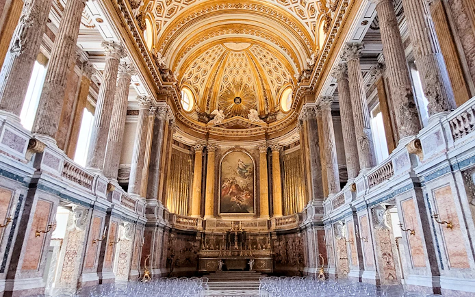 Palatine Chapel interior with ornate ceiling and columns, Royal Palace of Caserta, Italy.