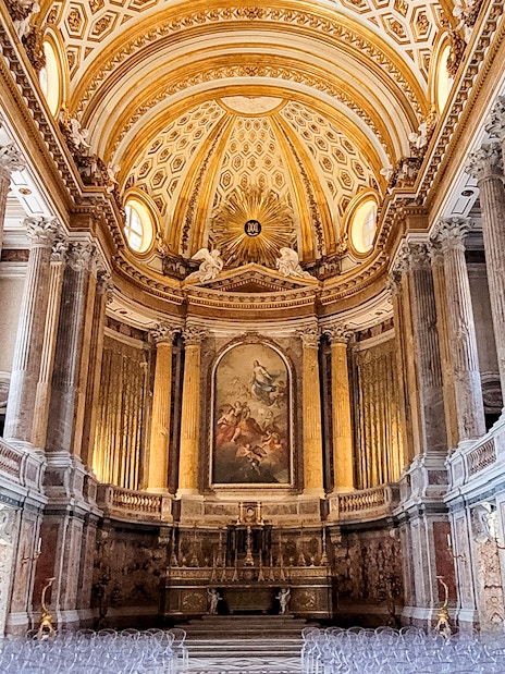 Palatine Chapel interior with ornate ceiling and columns, Royal Palace of Caserta, Italy.