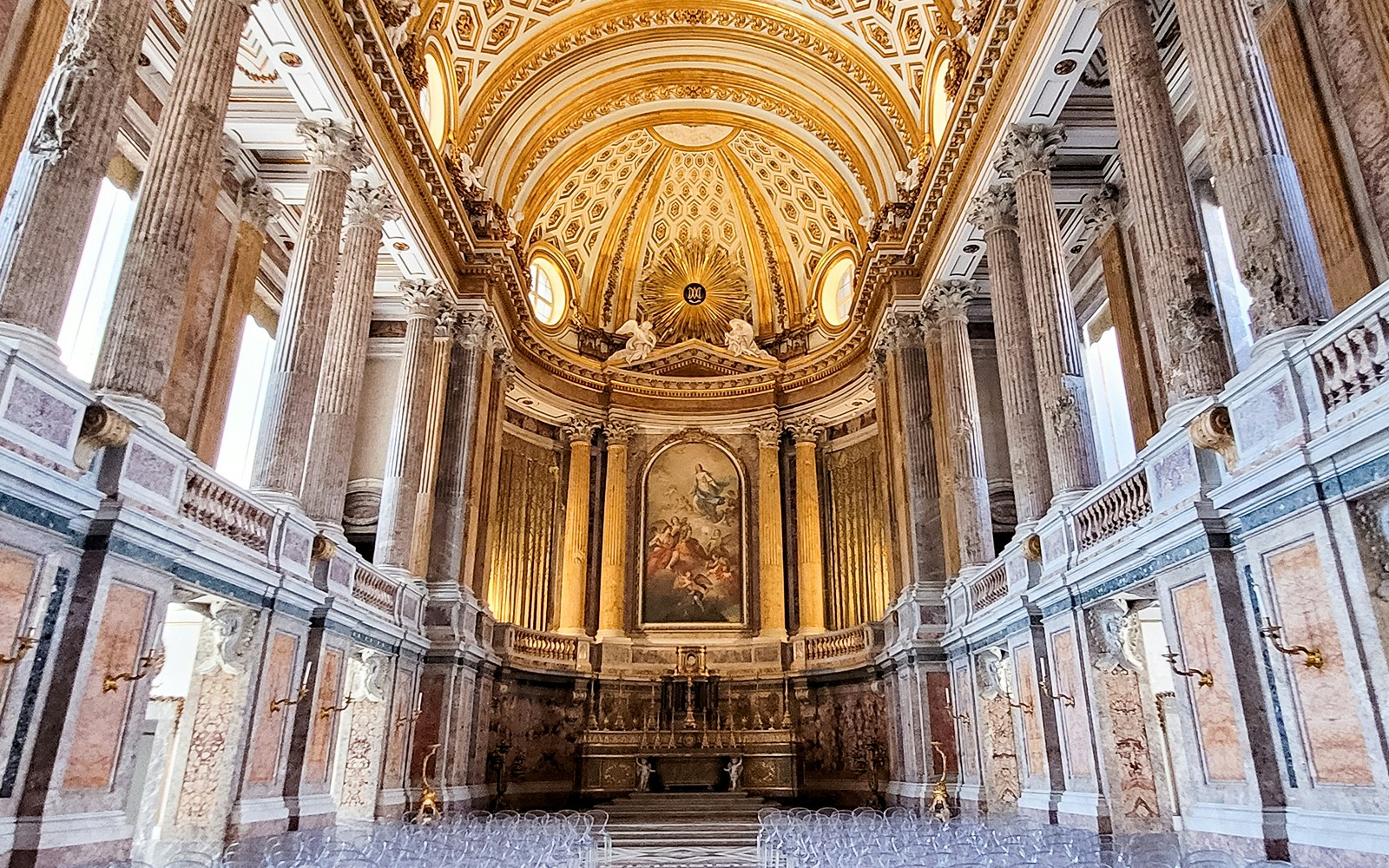 Palatine Chapel interior with ornate ceiling and columns at Royal Palace of Caserta, Italy.