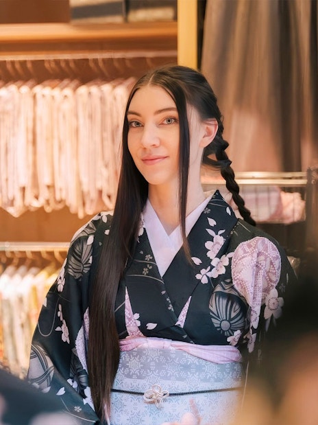 Tourist in kimono getting hair styled at rental service in Japan.