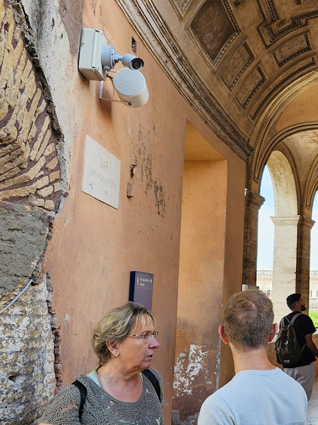 Visitors exploring the arched corridor of Castel Sant'Angelo in Rome.
