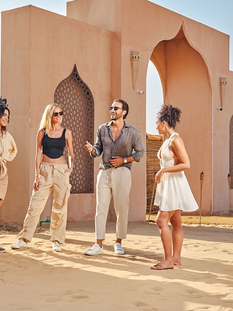 Group of friends enjoying Noble Camp Desert Safari entrance.