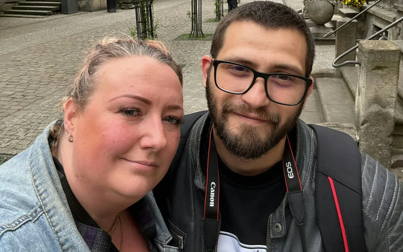 Two people smiling in Gdansk during the Watchmaker's Curse city exploration game.