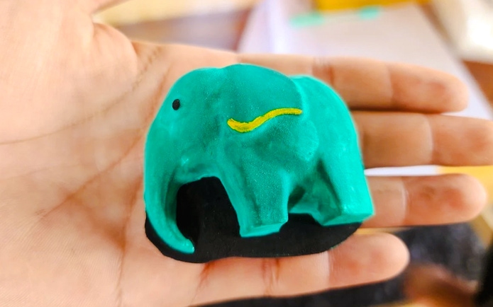 Painted elephant figurine in hand at Phuket Elephant Care.