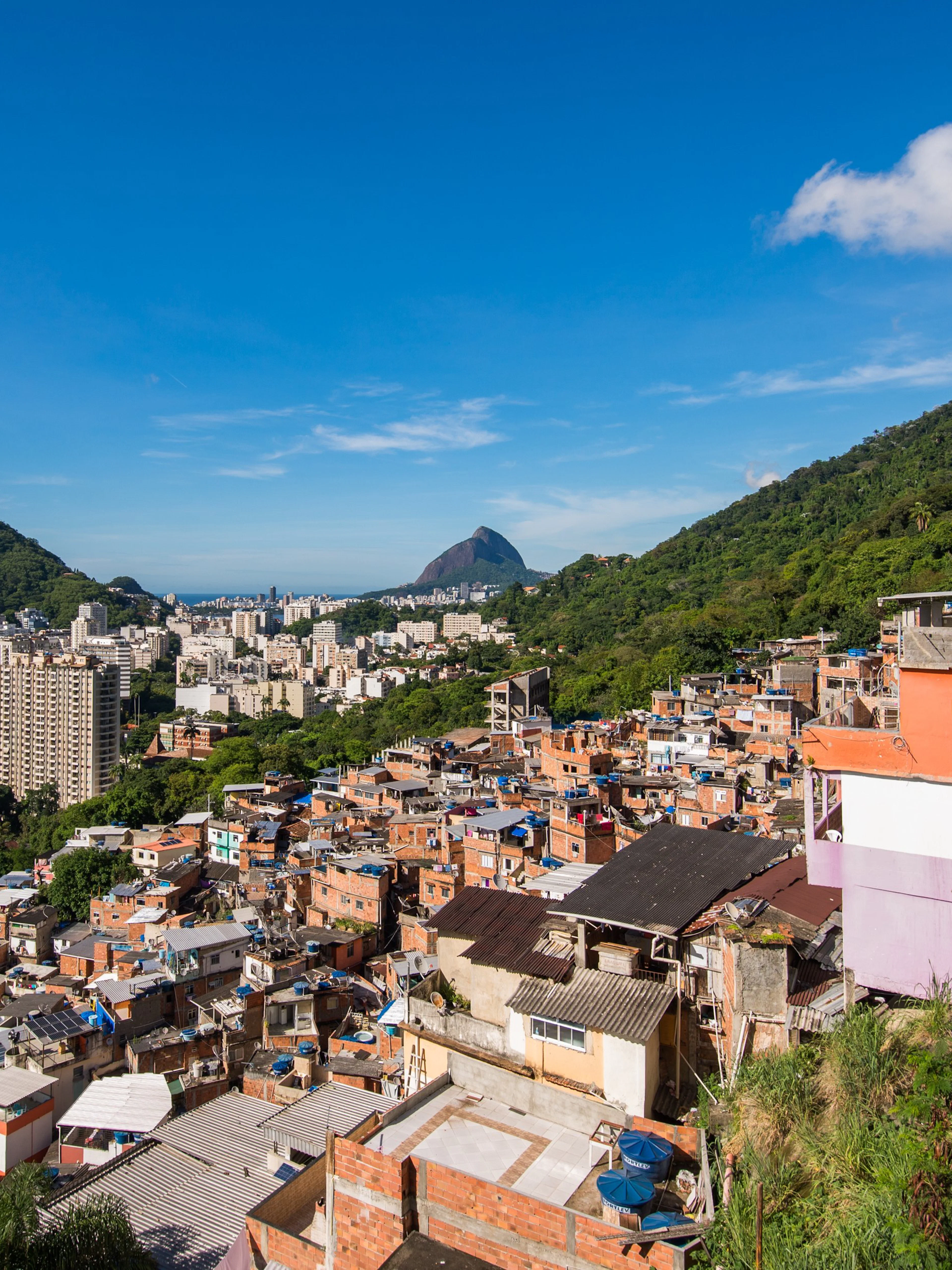 Houses of Santa Marta Favela with Corcovado Mountain in Rio de Janeiro in the background.