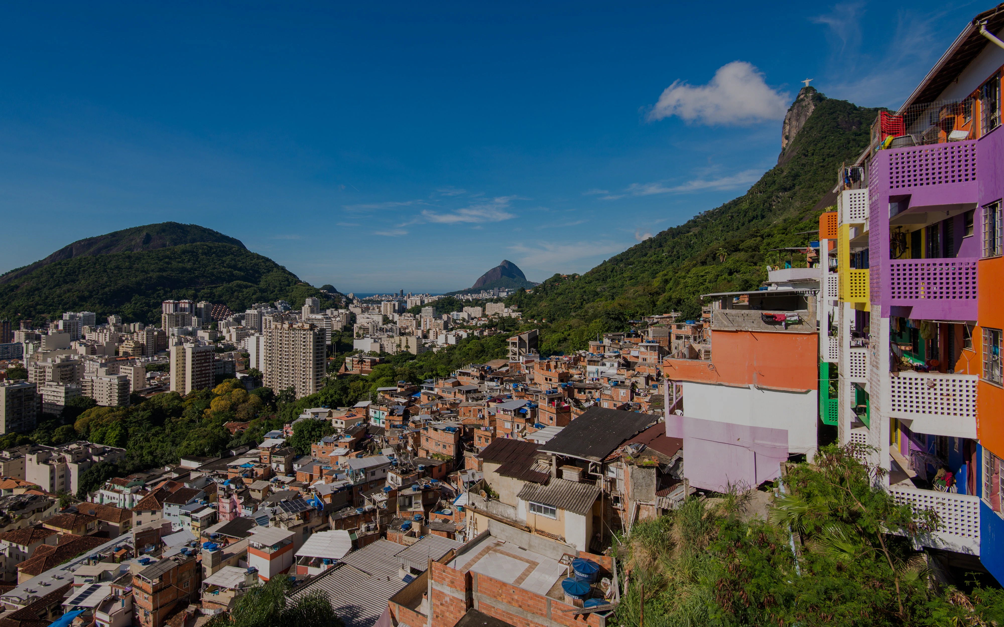 Houses of Santa Marta Favela with Corcovado Mountain in Rio de Janeiro in the background.