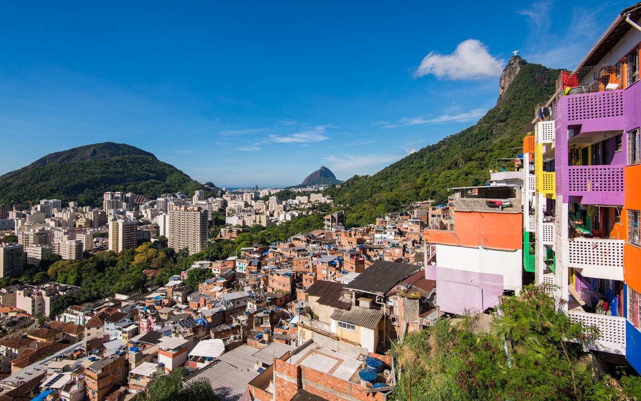 Houses of Santa Marta Favela with Corcovado Mountain in Rio de Janeiro in the background.