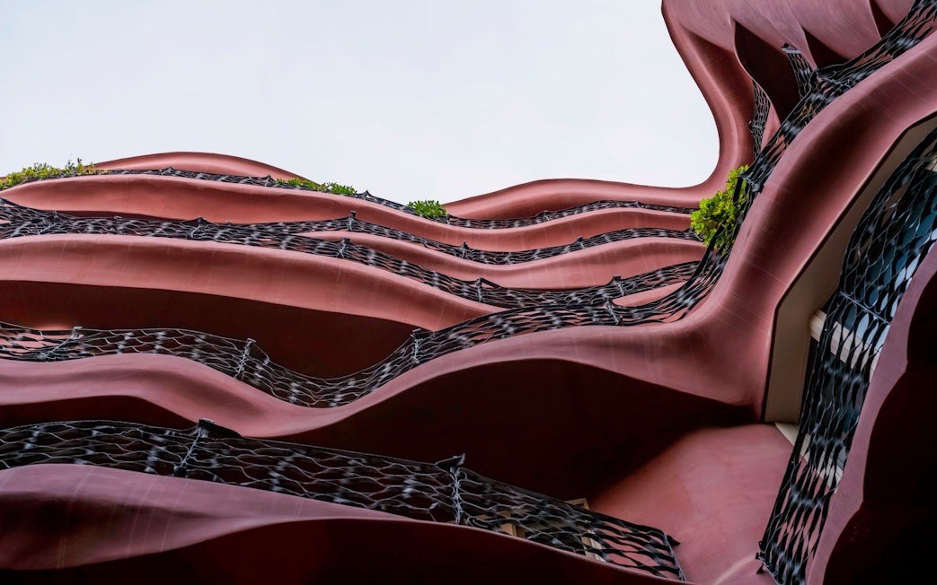 Wavy facade of Casa Mila, La Pedrera in Barcelona, showcasing unique architectural design.