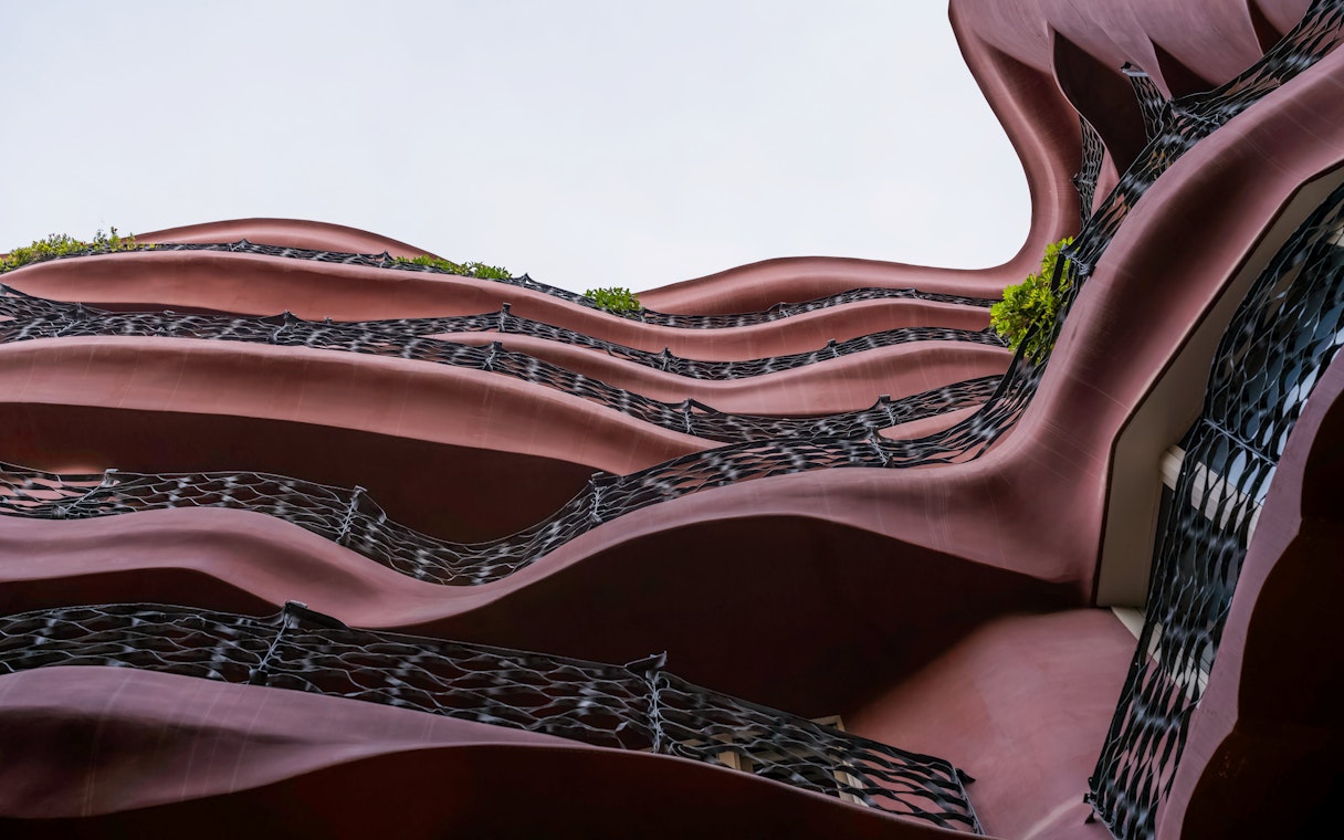 Wavy facade of Casa Mila, La Pedrera in Barcelona, showcasing unique architectural design.