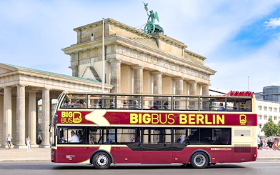Big Bus Berlin tour passing by the Brandenburg Gate.