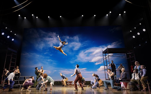 Performer leaping in a circus scene from "Water for Elephants" stage show.