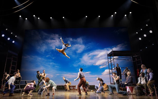 Performer leaping in a circus scene from "Water for Elephants" stage show.