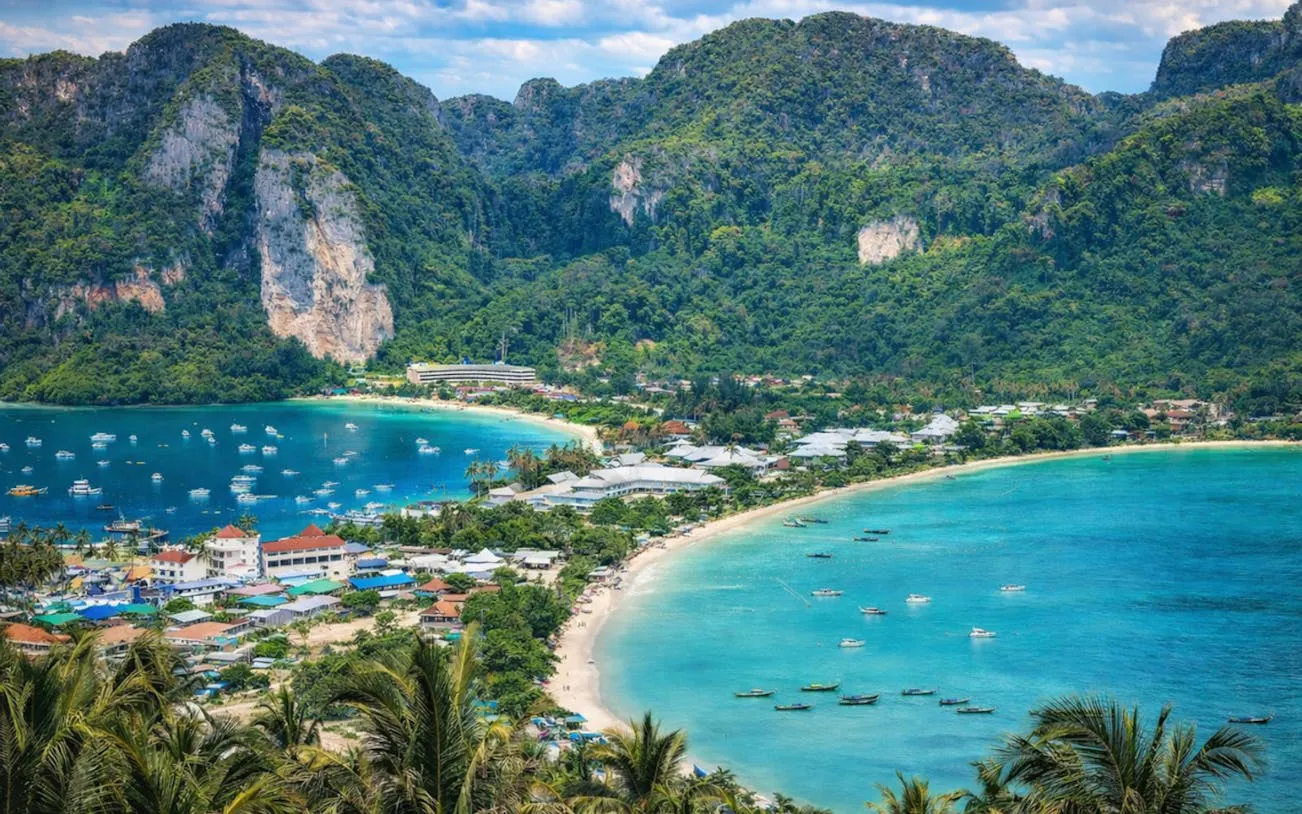 Aerial view of Phi Phi Islands with turquoise waters and lush cliffs, Thailand.