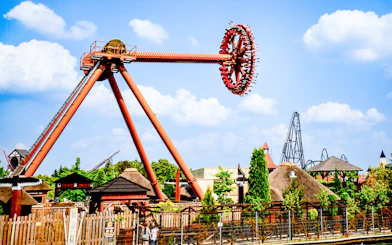 Ride at Energylandia Theme Park in Zator, Poland with people on a spinning attraction.
