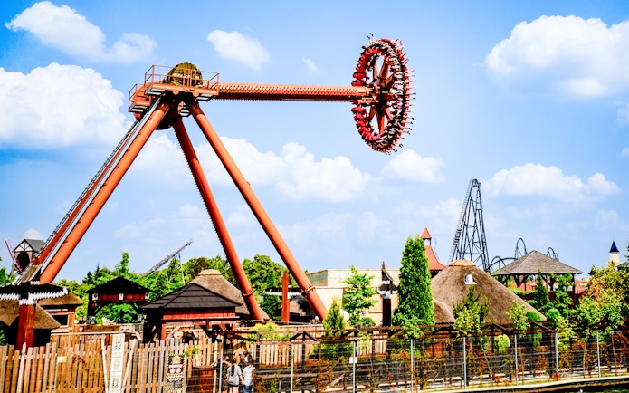 Ride at Energylandia Theme Park in Zator, Poland with people on a spinning attraction.