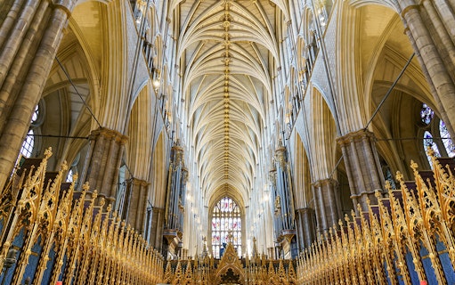 Interior of the coronation church with ornate arches and golden details, London, UK.