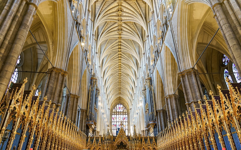 Interior of the coronation church with ornate arches and golden details, London, UK.
