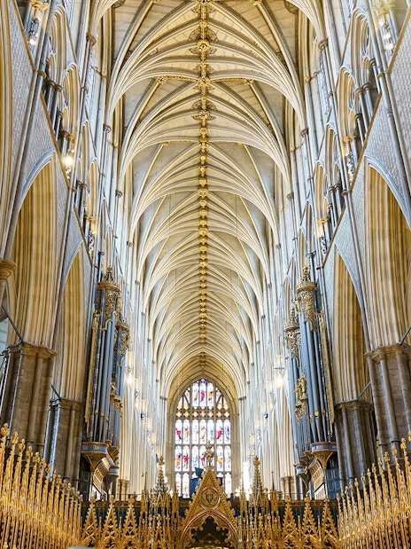Interior of the coronation church with ornate arches and golden details, London, UK.