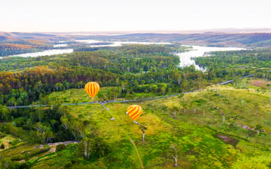 Hot air balloons over lush landscape, Gold Coast, Australia.